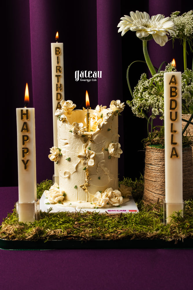 Gateau Gourmet Cafe cake with white garden candlelight arrangement featuring floral decorations and personalized candles