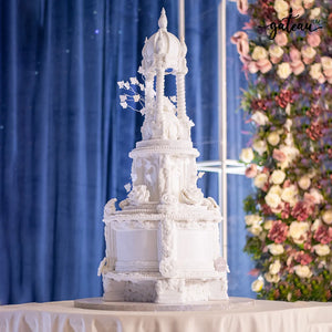 White gazebo wedding cake by Gateau Gourmet Cafe with intricate floral and architectural details