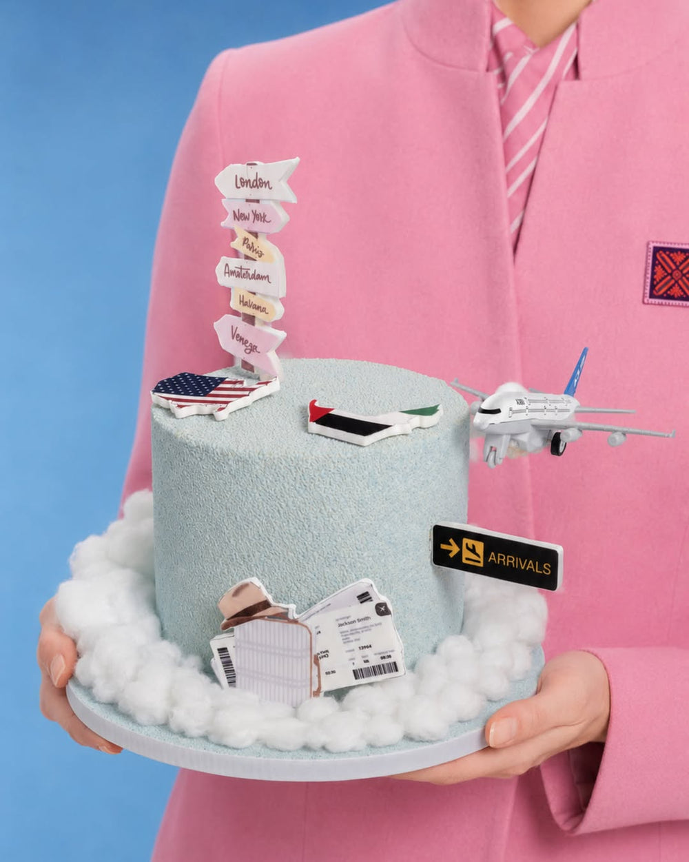 Travel and Adventure Welcome Back Cake — travel-themed cake with aeroplane, boarding pass, arrival sign and destination signposts