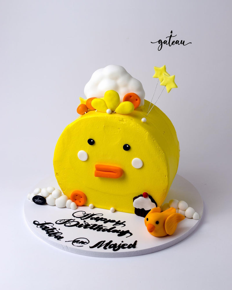 Gateau Gourmet Cafe yellow Gibbous Cake design with a duck face, star decorations, and birthday message on white base