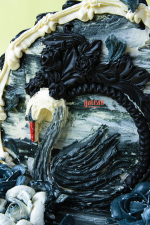Elegant Gibbous cake for celebrations featuring intricate black and white swan design by Gateau Gourmet Cafe