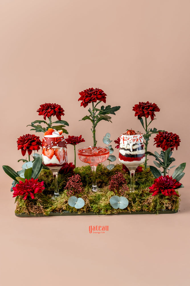 Beautiful goblet cake arrangement featuring vibrant flowers and delicious layered desserts displayed elegantly