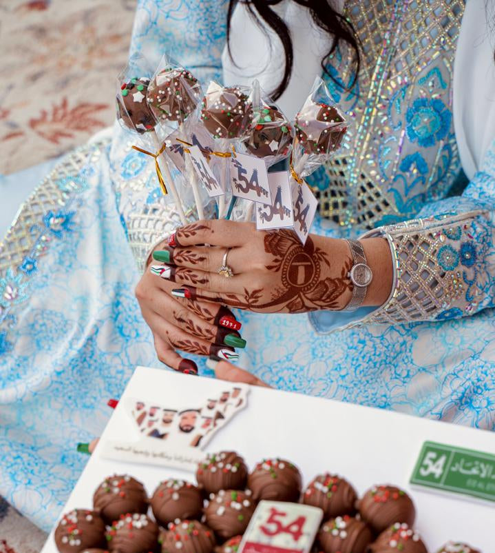 Colorful gourmet cake pops displayed on a stick, perfect for celebrations from Gateau Gourmet Cafe