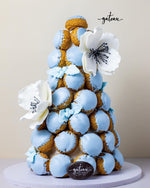 Gateau Gourmet Cafe tower of blue glazed gourmet choux pastries decorated with white edible flowers