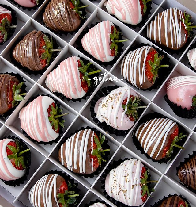 Gateau Gourmet Cafe gourmet dipped strawberries in assorted white, pink, and milk chocolate with decorative drizzles