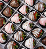 Gateau Gourmet Cafe gourmet dipped strawberries in assorted white, pink, and milk chocolate with decorative drizzles