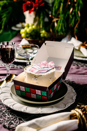 Gourmet holiday cakes by Gateau Gourmet Cafe in decorative box on festive table setting