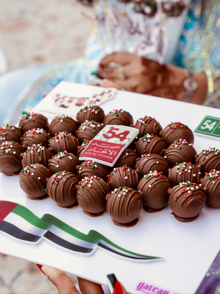 Gourmet truffles gift board featuring assorted chocolate truffles with colorful decorations