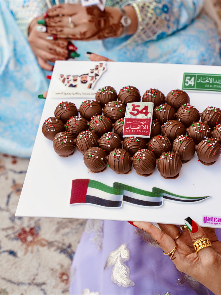 Gourmet truffles gift board from Gateau Gourmet Cafe decorated with festive sprinkles and UAE theme