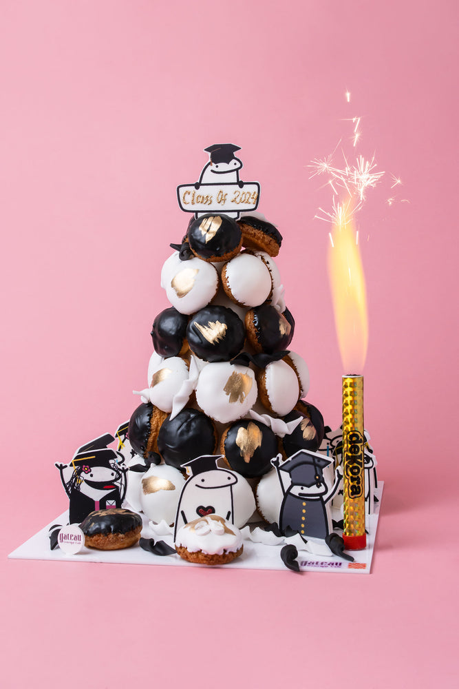 Gateau Gourmet Cafe graduation celebration cakes tower decorated with black and white pastries and graduation-themed toppers