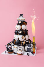 Gateau Gourmet Cafe graduation celebration cakes tower decorated with black and white pastries and graduation-themed toppers