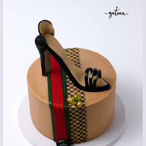 Gucci shoes on a box cake featuring a stylish stiletto and festive decorations from Gateau Gourmet Cafe