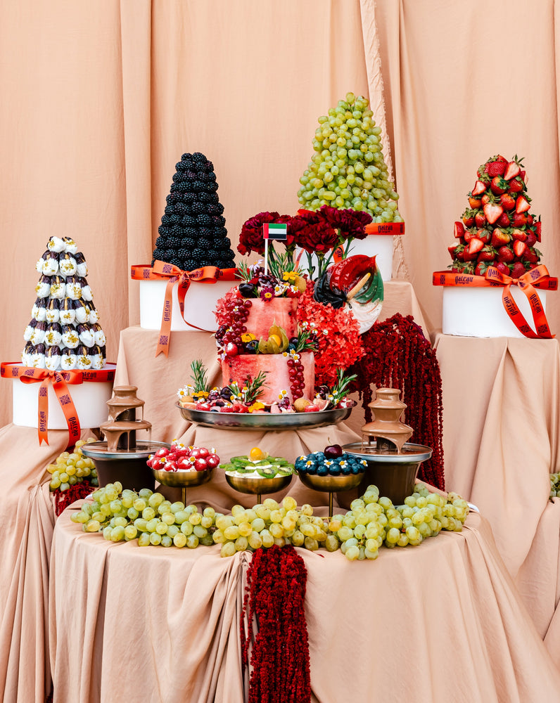 Guilt free fruit dessert display featuring colorful fruits and elegant cake at Gateau Gourmet Cafe