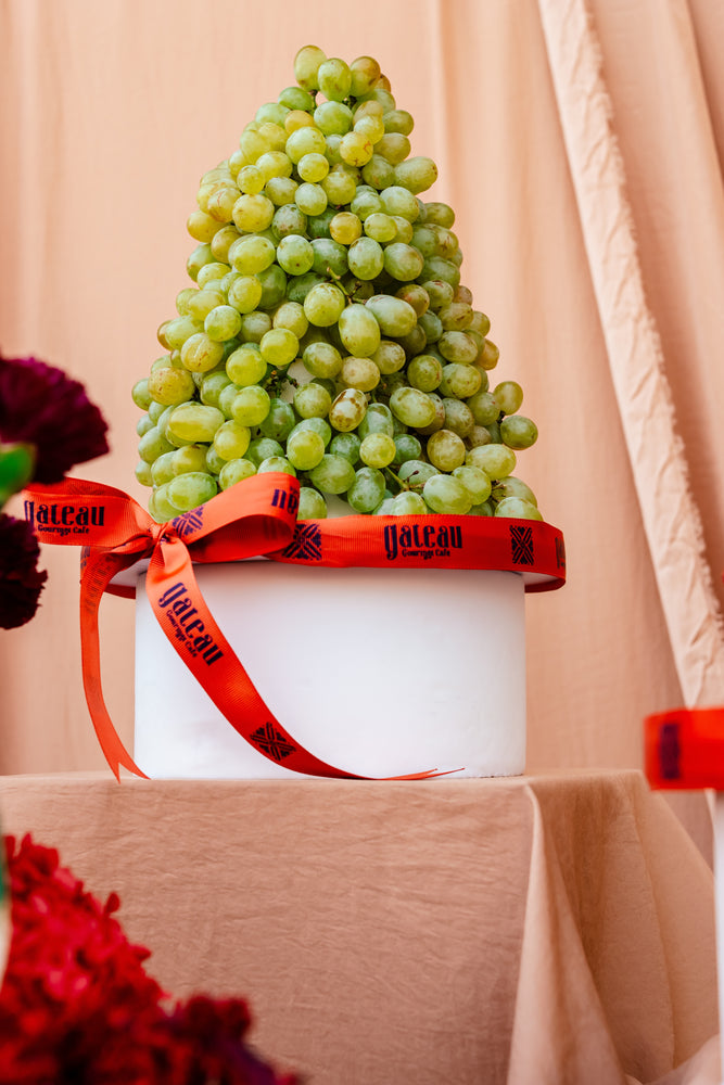 Guilt free fruit dessert shaped like a pyramid made of fresh green grapes from Gateau Gourmet Cafe