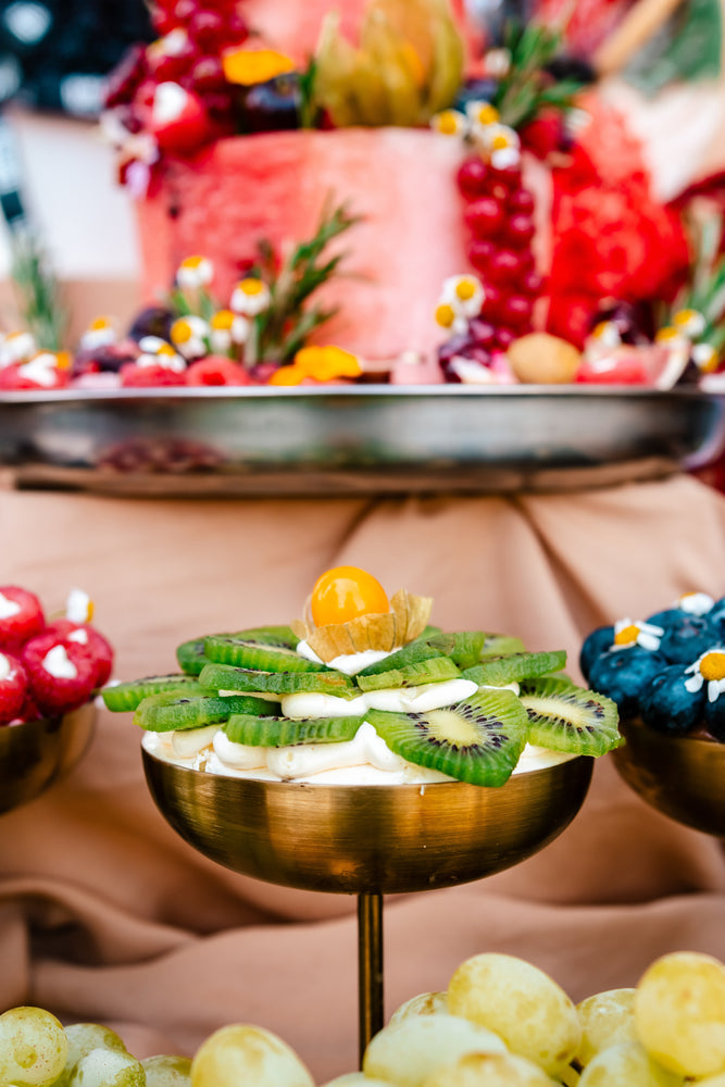 Guilt free fruit dessert featuring fresh kiwi, berries, and tropical fruits served elegantly in a gold bowl