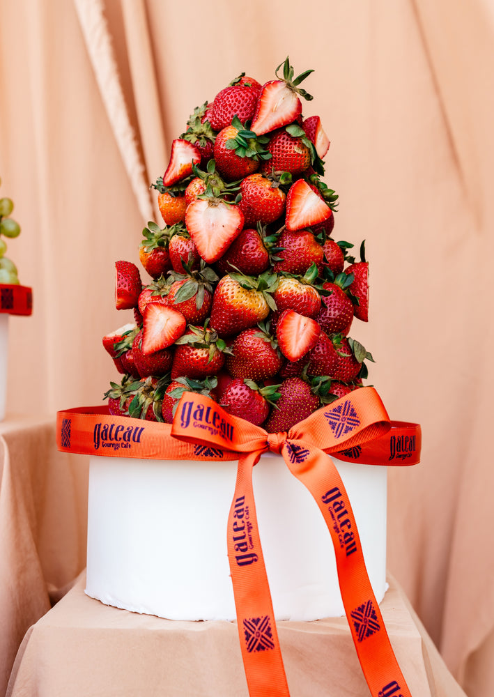 Guilt free fruit dessert featuring a towering display of fresh strawberries from Gateau Gourmet Cafe