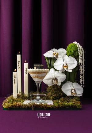 Elegant Hajj celebration cake with white orchids and decorative candles by Gateau Gourmet Cafe