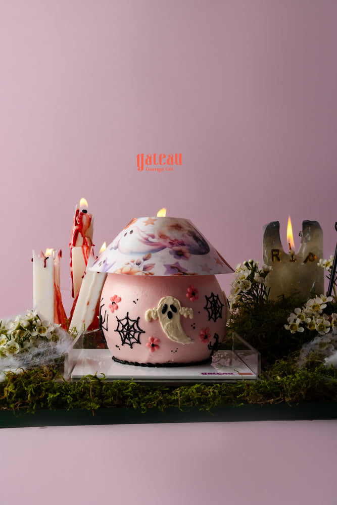 Halloween celebration cake with decorations featuring ghost and spider designs for festive parties