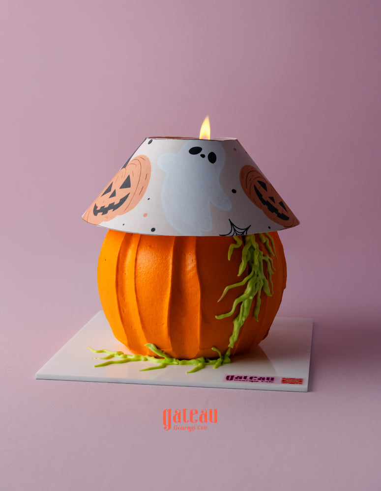 Halloween lamp cake designed as a pumpkin with ghost and jack-o-lantern details, perfect for festive celebrations