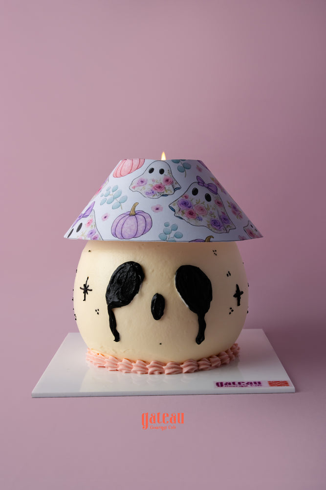 Unique Halloween lamp cake shaped like a skull with a decorative lampshade design