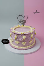 Handcrafted Mother's Day cake by Gateau Gourmet Cafe with purple and yellow floral frosting decoration