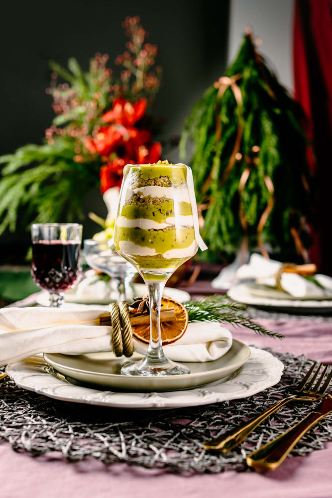 Layered cake dessert served in a wine glass on a festive holiday table, perfect holiday desserts for parties