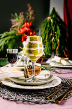 Layered cake dessert served in a wine glass on a festive holiday table, perfect holiday desserts for parties