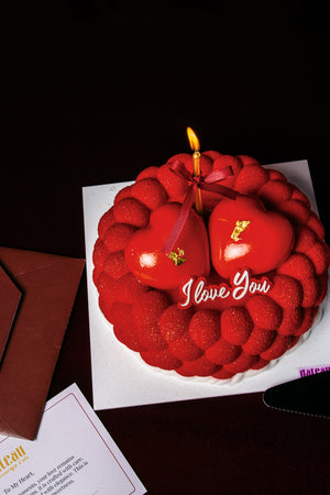 Gateau Gourmet Cafe red heart shaped cake with I love you dessert text and candle for romantic occasions