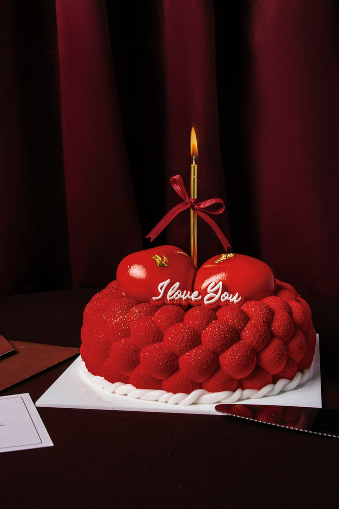 Gateau Gourmet Cafe red heart cake with I love you dessert message and single lit candle on top