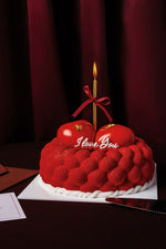Gateau Gourmet Cafe red heart cake with I love you dessert message and single lit candle on top
