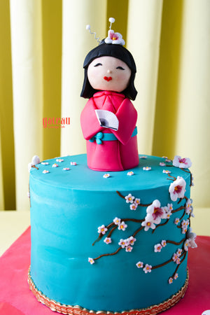 Gateau Gourmet Cafe cake with Japanese doll cake design featuring cherry blossoms on blue icing