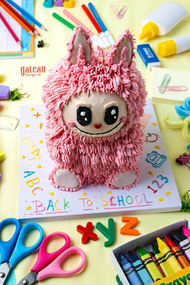 Colorful Labubu back to school cake displayed on a themed table with school supplies