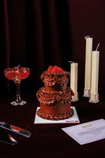 Lace Classic Mini Cake With Candle topped with raspberries beside a cocktail and decorative candles