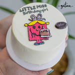 Little Miss themed cake decorated with a character holding a birthday cake for celebrations