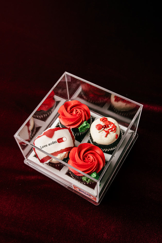 Beautiful Love On Cup Cake display featuring red rose designs and sweet decorations in a clear box