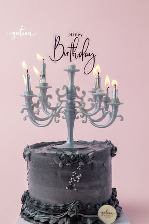 Gateau Gourmet Cafe Lumiere cake for special occasions with black frosting and decorative candles