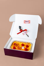 Lunch box creme brulee with fresh raspberries in a decorative container from Gateau Gourmet Cafe
