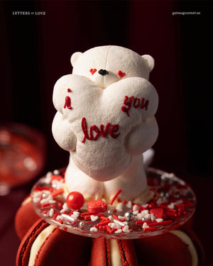 Macaroon Tower With Candle featuring a cute bear holding an 'I love you' heart decoration
