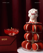 Beautiful Macaroon Tower With Candle featuring red macarons and a cute love-themed decoration