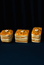Three layered Mango Fruit Treats topped with mango slices and pistachios from Gateau Gourmet Cafe