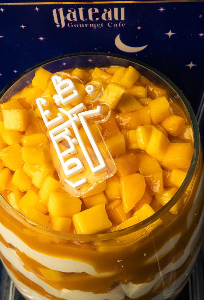 Delicious Mango Goblet from Gateau Gourmet Cafe topped with fresh mango chunks and creamy layers