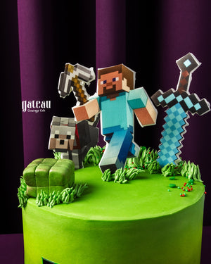 Minecraft themed cake with 3D characters, grass details, and festive decorations from Gateau Gourmet Cafe