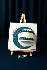 Mini-canvas-cake from Gateau Gourmet Cafe with blue frosting and star decor on a display stand