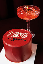 Mini Love Red Cake With Candle featuring rich red frosting and a chocolate message for special celebrations