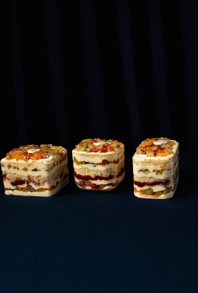 Three layers of Mixed Fruit Treats from Gateau Gourmet Cafe with vibrant colorful fruits.