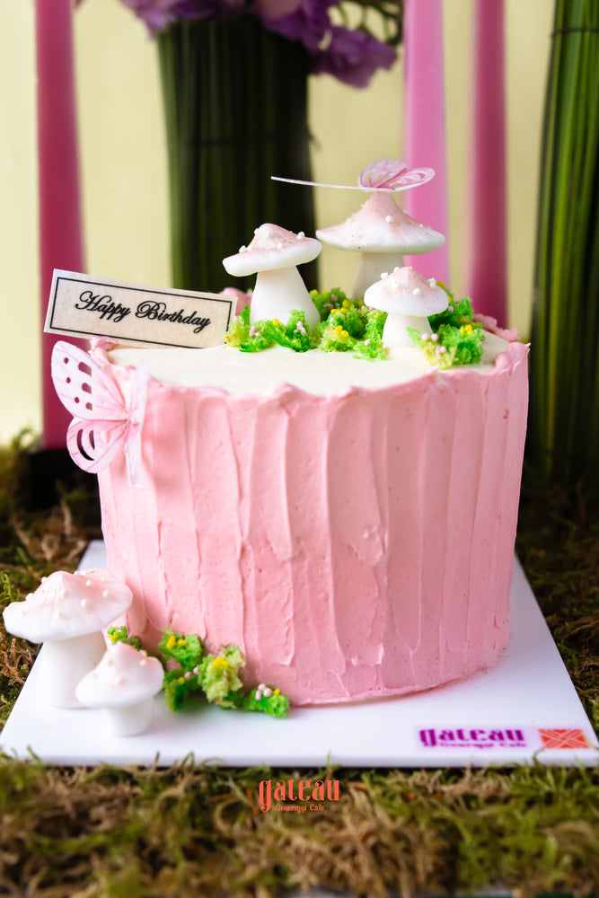 Mushroom cake with floral arrangement featuring delicate mushrooms and a pink buttercream finish
