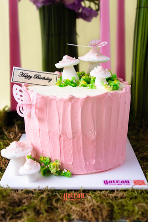 Mushroom cake with floral arrangement featuring delicate mushrooms and a pink buttercream finish