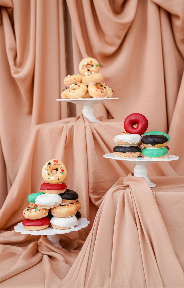 Festive National Day mini donuts displayed on elegant pedestals with colorful icing and sprinkles