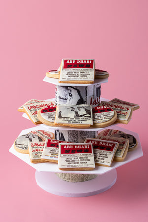 Delicious news headlines cookies from Gateau Gourmet Cafe arranged on a decorative stand