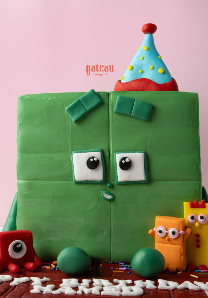 Number Blocks birthday cake in green with playful characters for a fun celebration